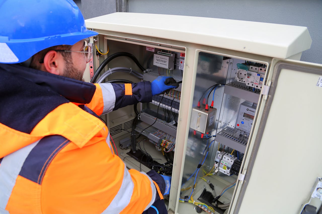 heros-img Engineer in safety gear working on an outdoor electrical panel, ensuring system functionality.